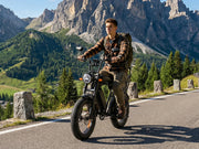 Man riding a motorcycle on a scenic mountain road