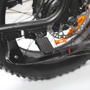 Close-up of a motorcycle's foot peg and wheel on a white background
