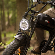 Electric bike with a headlight in a forest setting