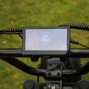 Digital display on a bicycle handlebar with a blurred green background