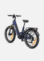 A navy blue electric bicycle with black components, orange wheel reflectors, and a rear cargo rack, shown from a three-quarters angle on a light gray background.