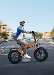 Man riding an orange electric bike on a city street
