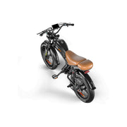 A black electric bicycle with a brown leather seat, shown from a high-angle perspective on a clean white background. The bike features thick tires, a digital display on the handlebars, and the brand name 'WEEK' visible on the frame.