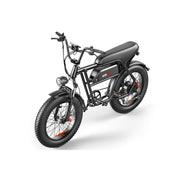A black electric fat-tire bike with a step-through frame, black seat, front headlight, and orange accent details on the wheels, shown on a clean white background.
