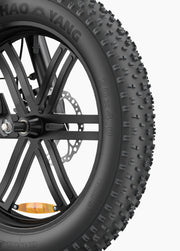 Close-up of a motorcycle tire with visible branding on a white background